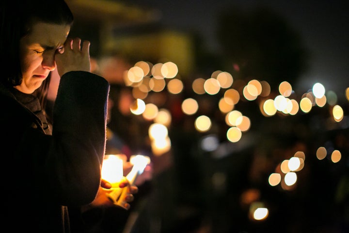 Community members gather during a candlelight vigil to honor the victims of the mass shootings at the Inland Regional Center December 3, 2015 at San Manuel Stadium in San Bernardino, California.