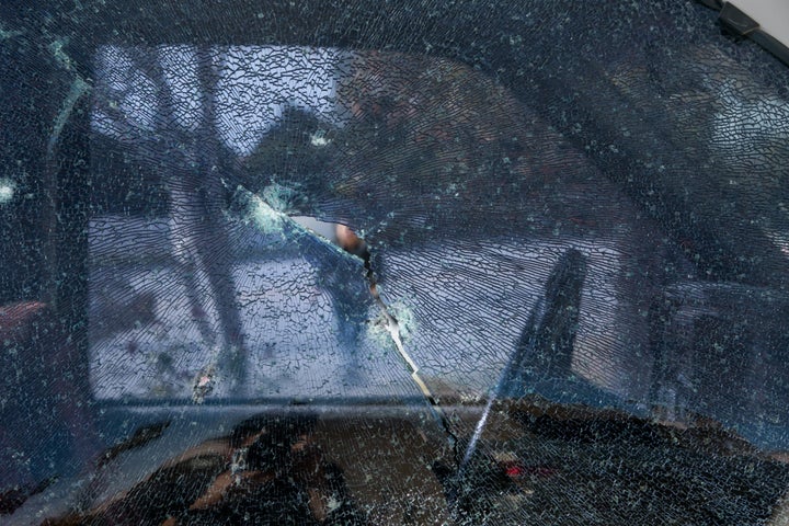 Bullet holes are seen in the window of a pickup truck near the site of a shootout between police and suspects between police