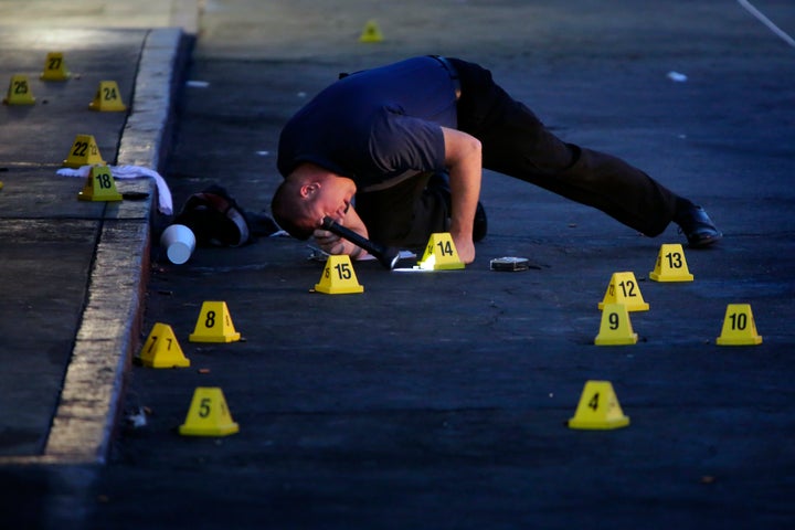 San Bernardino police detective B. Lewis investigates on July 8, 2014 a fatal shooting incident that occurred the previous night.