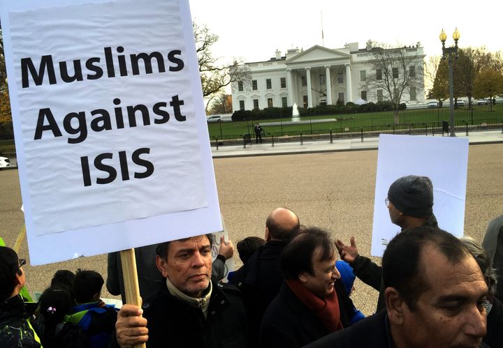 A Shiite Muslim holds a banner in protest against ISIS and violence in the name of Islam during a religious procession at Lafayette Square, outside the White House on December 06, 2015.