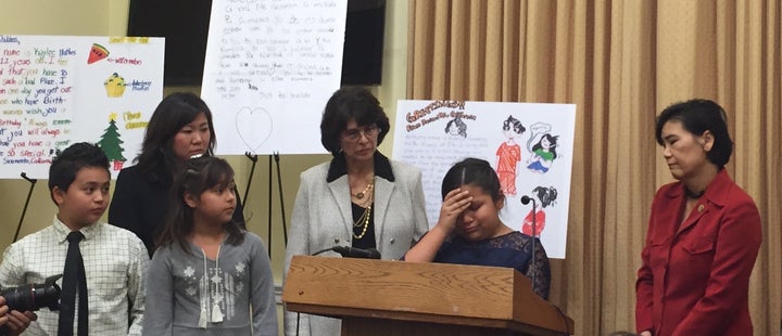 Nine-year-old Fiorella Zuniga, flanked by California Reps. Lucille Roybal-Allard (left) and Judy Chu (right), began to c