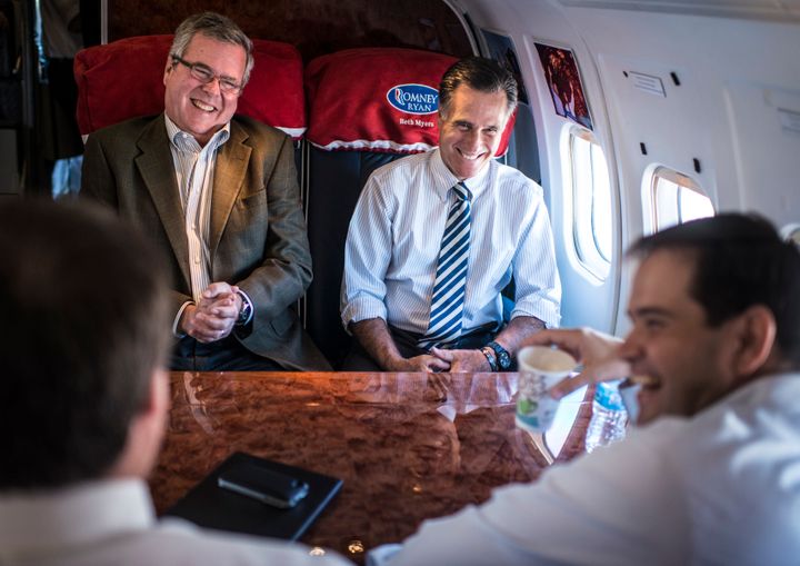 Jeb Bush, Mitt Romney and Marco Rubio share a laugh on Romney's campaign plane in October 2012.