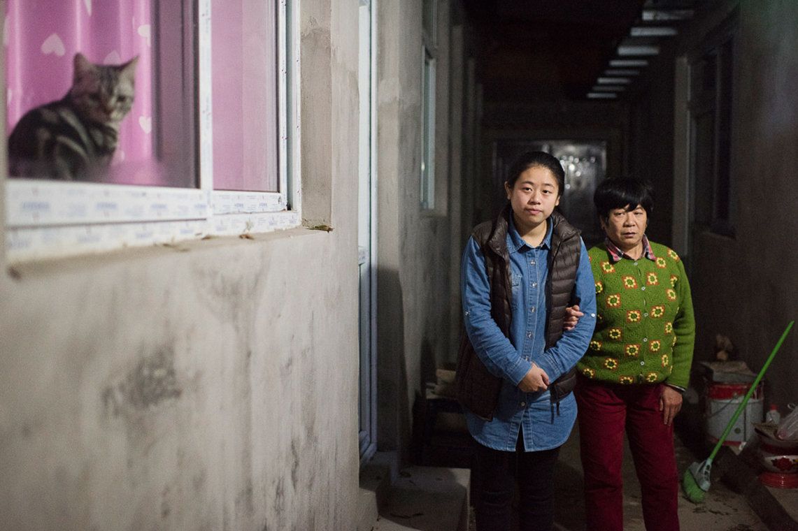 Li Xue and her mother outside their Beijing home.