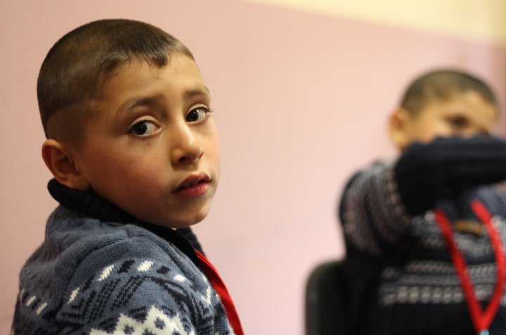 A Syrian boy participates in a music exercise during a Project Lift workshop. 