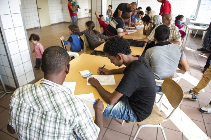 Refugees arriving in Germany fill out screening forms on August 13, 2015.