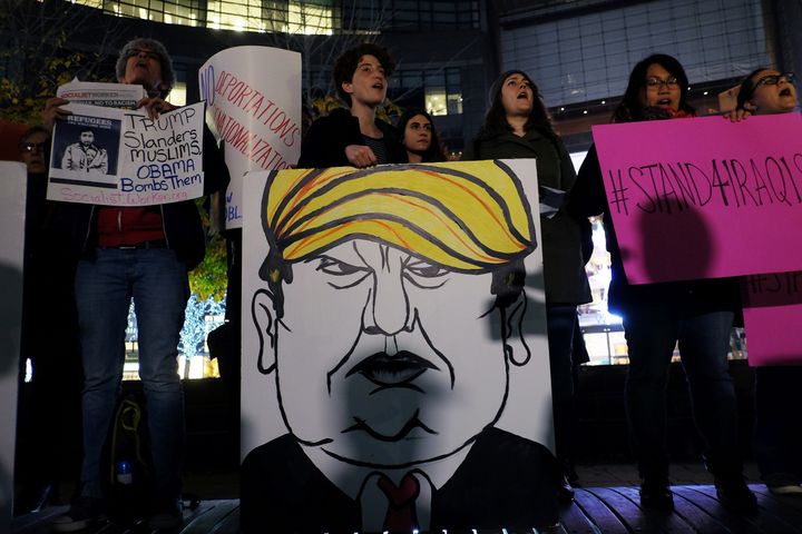 Activists and people from the Muslim community display a placard depicting Donald Trump at a New York City demonstration in solidarity with Syrian and Iraqi refugees Thursday. 
