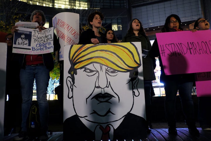Activists and people from the Muslim community display a placard depicting Donald Trump at a New York City demonstration in solidarity with Syrian and Iraqi refugees Thursday.