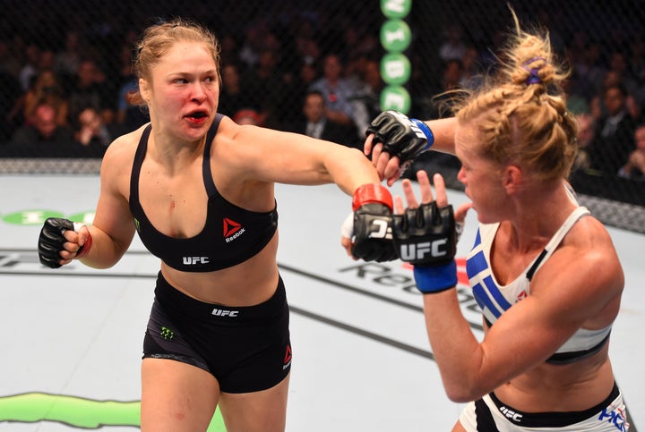 Ronda Rousey (L) punches Holly Holm (R) in their UFC women's bantamweight championship bout in Melbourne, Australia, on Nov.