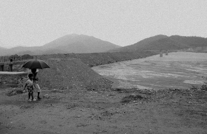 People walk by the highly radioactive river.