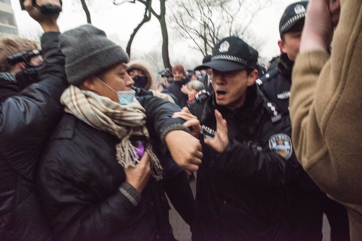 Chinese police push away journalists and supporters of human rights lawyer Pu Zhiqiang demonstrating near the Beijing Second Intermediate People's Court in Beijing Monday.