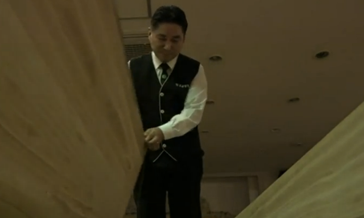 A Hyowon Healing Center program team member prepares to close a coffin.