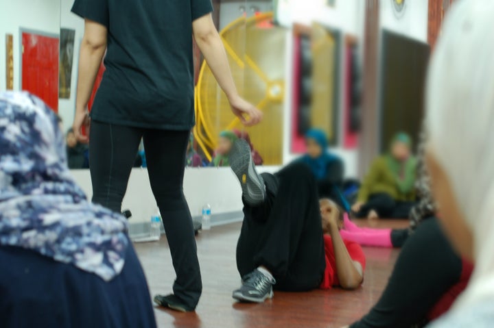 Instructor Daniels teaches women how to fall and kick their attacker.