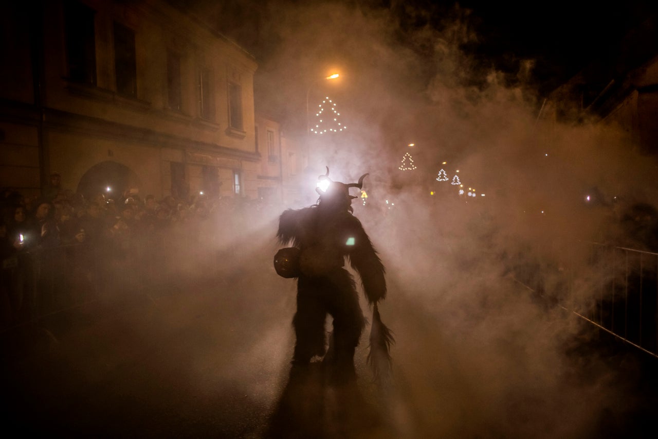 Krampus carries a bundle of sticks, with which he beats naughty children. This Krampus is taking part in a festival in Kaplice, Czech Republic.