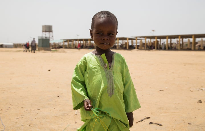 A Chadian kid holds bottle taps at a slumdog of N'djamena, Chad on June 22, 2015.
