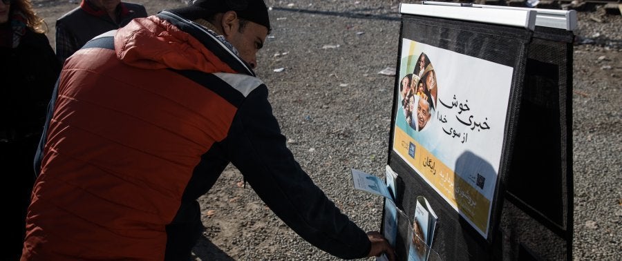Jehovah's Witnesses set up stands with articles in English and Arabic. 