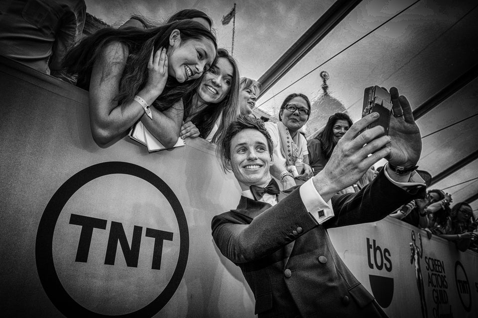 Eddie Redmayne taking a selfie with fans