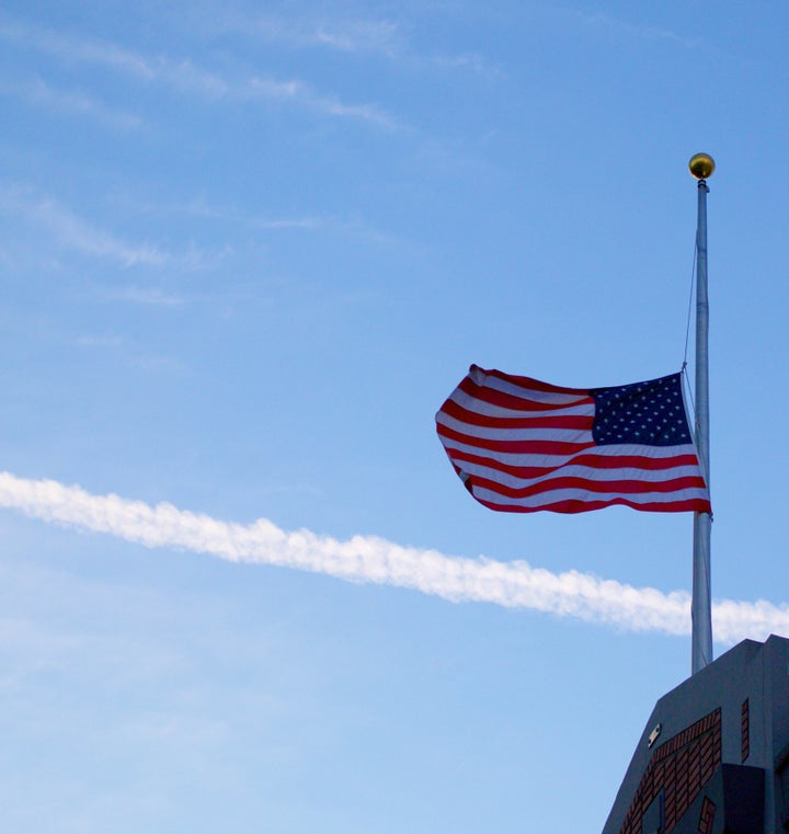 An American flag flies at half mast. A HuffPost/YouGov poll shows Americans concerned about terrorism and gun violence, but more personally worried about job loss and illness.