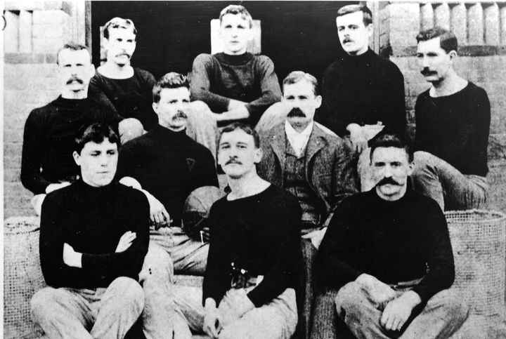 Dr. James Naismith (1861 - 1939) with his first basketball team in Springfield, Massachusetts, 1891. 