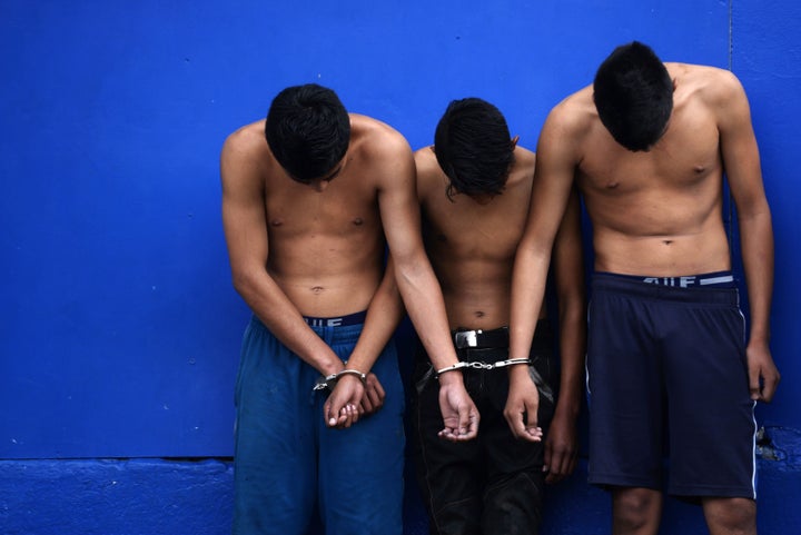 Suspects accused of several crimes are presented to the media after an operation in search of 18th Street gang members hidden in a mountainous area in Ayutuxtepeque, 4 km north of San Salvador, on October 25, 2015. After an intense shootout between police and alleged gang members, three young people were killed and others four were captured while carrying three rifles M16 and one AK-47, ammunition and military clothing.