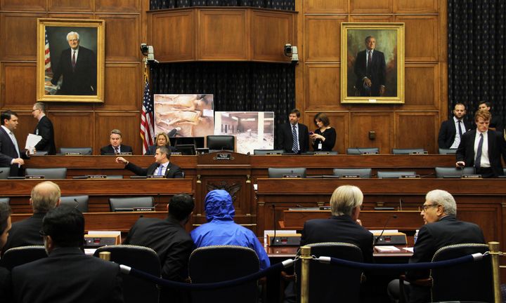 The Syrian defector known as Caesar, in a blue hooded jacket, briefed the U.S. House Committee on Foreign Affairs last July.