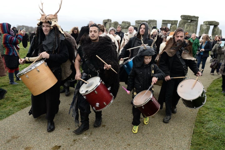 Revelers take part in celebrations to mark the winter solstice at Stonehenge on December 22, 2014 in Amesbury, England. About 1,500 revellers, druids and pagans gathered at the monument to celebrate the solstice, a tradition believed to date back thousands of years.