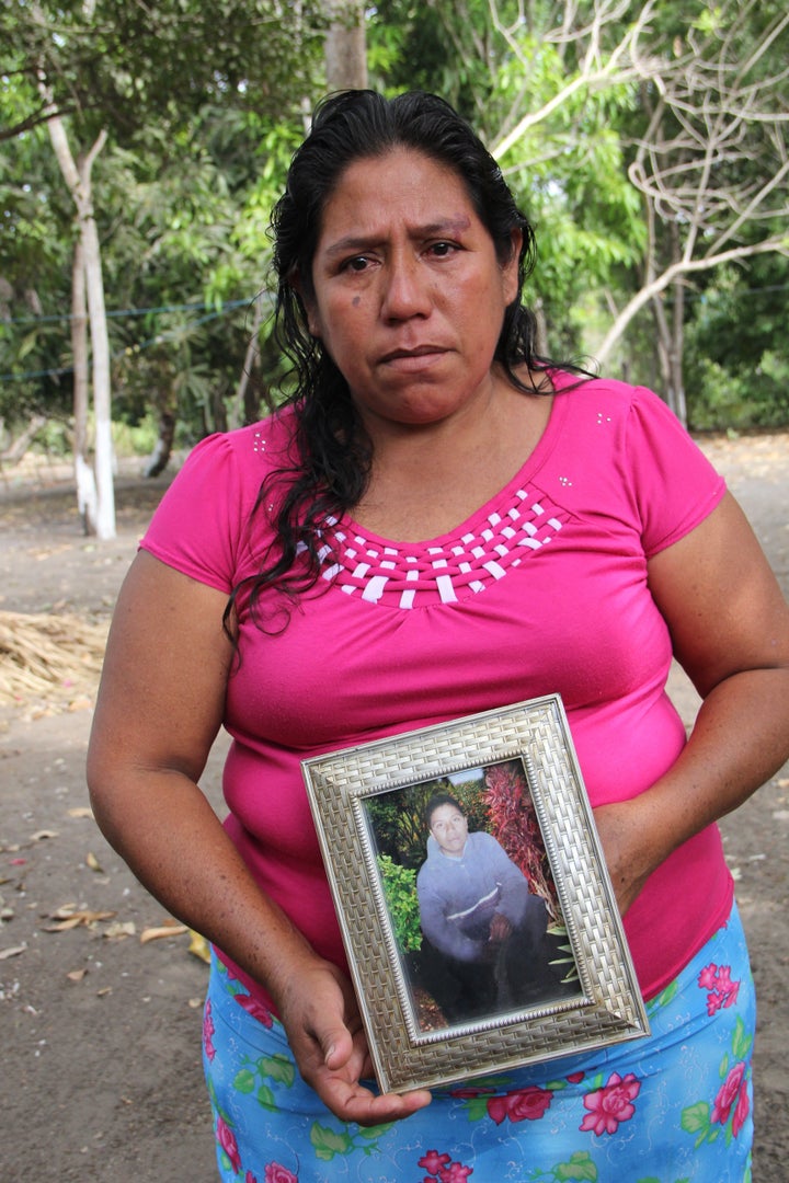 Roselia Diaz, mother of dead castaway Ezequiel Córdoba, shows her son's portrait.