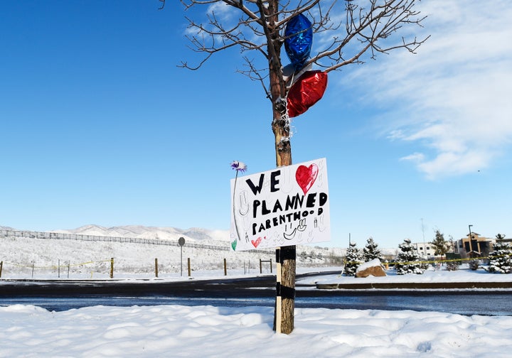 A sign supporting Planned Parenthood hangs near the entrance of the Planned Parenthood facility in Colorado Springs after a gunman killed three people there.