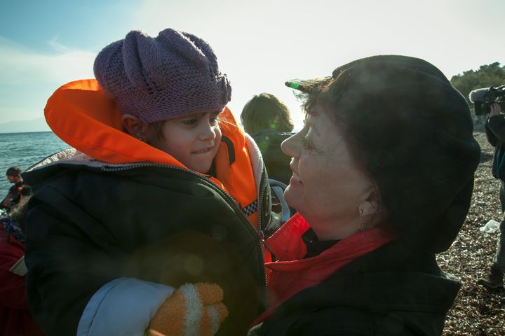 Susan Sarandon greets a 5-year-old Iranian refugee as she arrives on the shore of Lesbos, Greece.