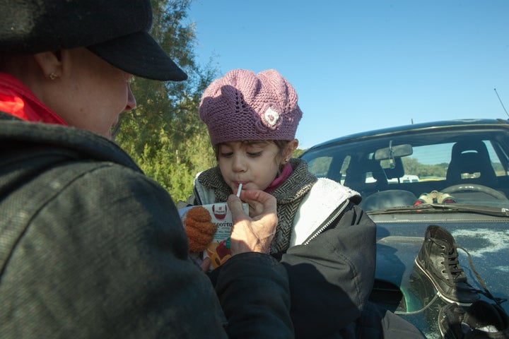 Susan Sarandon gives a 5-year-old refugee a juice box in Lesbos, Greece.