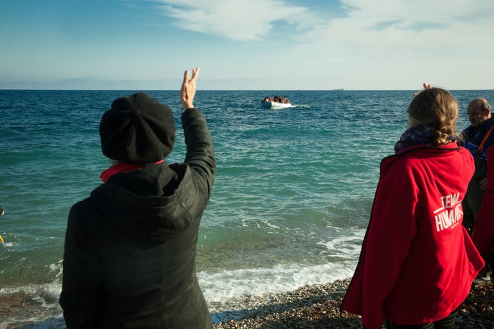 Susan Sarandon and other volunteers greet a boat of refugees in Lesbos, Greece.