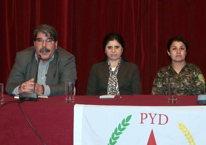 PYD co-presidents Saleh Muslim Mohammed (L) and Asya Abdullah with Syrian Kurdish fighter Nasrin Abdullah (R) at a press conference in Paris, France, on Feb. 9, 2015.