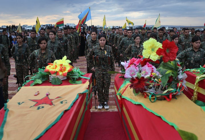 Members of the female division of the Syrian Kurdish militia, the YPJ, take part in the funeral of eight comrades on Nov. 8, 2015, in Derek, Rojava, Syria.