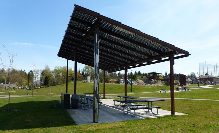 A couple of dozen solar panels sit atop a picnic shelter at a neighborhood park in Seattle.