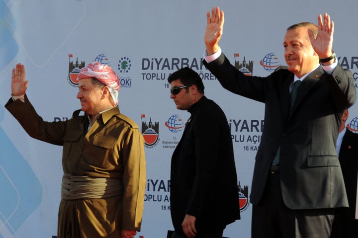 Turkish Prime Minister Recep Tayyip Erdogan (R) and Iraqi Kurdish leader Massud Barzani (L) wave on November 16, 2013 in the southeastern Turkish city of Diyarbakir.