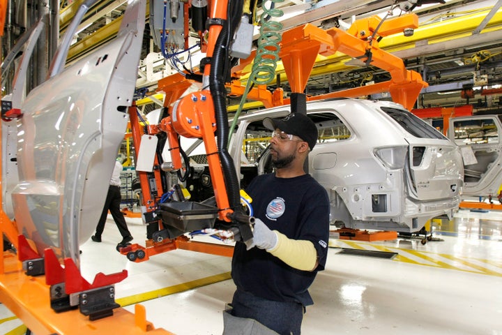 A Chrysler employee works on the assembly line making the new Jeep Grand Cherokee at the Chrysler Jefferson Avenue Plant, May