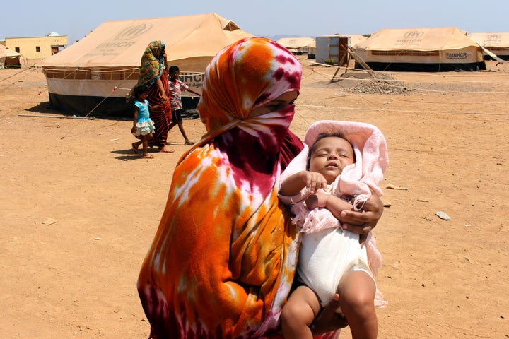 OBOCK, DJIBOUTI - MAY 18: A Yemeni woman with his baby, fled the air strikes that have devastated their country, takes shelter at UNHCR's refugee camp site in Obock region of Djibouti on May 18, 2015. The UN expects more than 15,000 Yemeni refugees will arrive in the next six months in Djibouti, where the government says it will offer them what support it can.