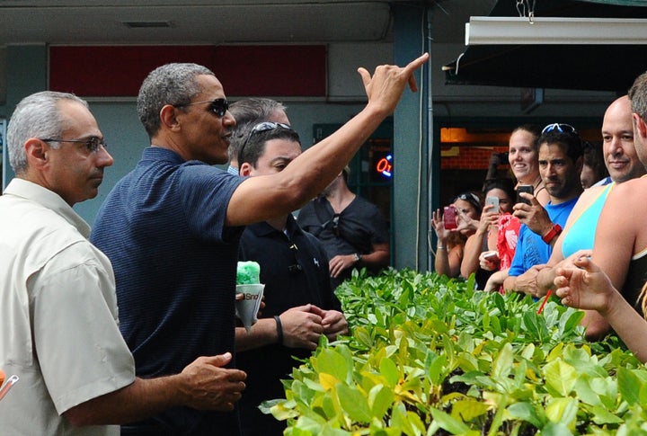 Obama waves a shaka to a crowd after buying "shave ice."