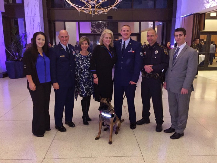 K9s4COPS Social Media Director Madison Sperry, Lt. Col. Glen Roberts, K9s4COPS Executive Director Roseann Rogers, K9s4COPS Founder Kristi Schiller, First Sergeant Spencer Stone, Deputy Ted Dahlin and K9s4COPS Director of Strategic Development Jeffrey Chatman. In front: K9 Quelle