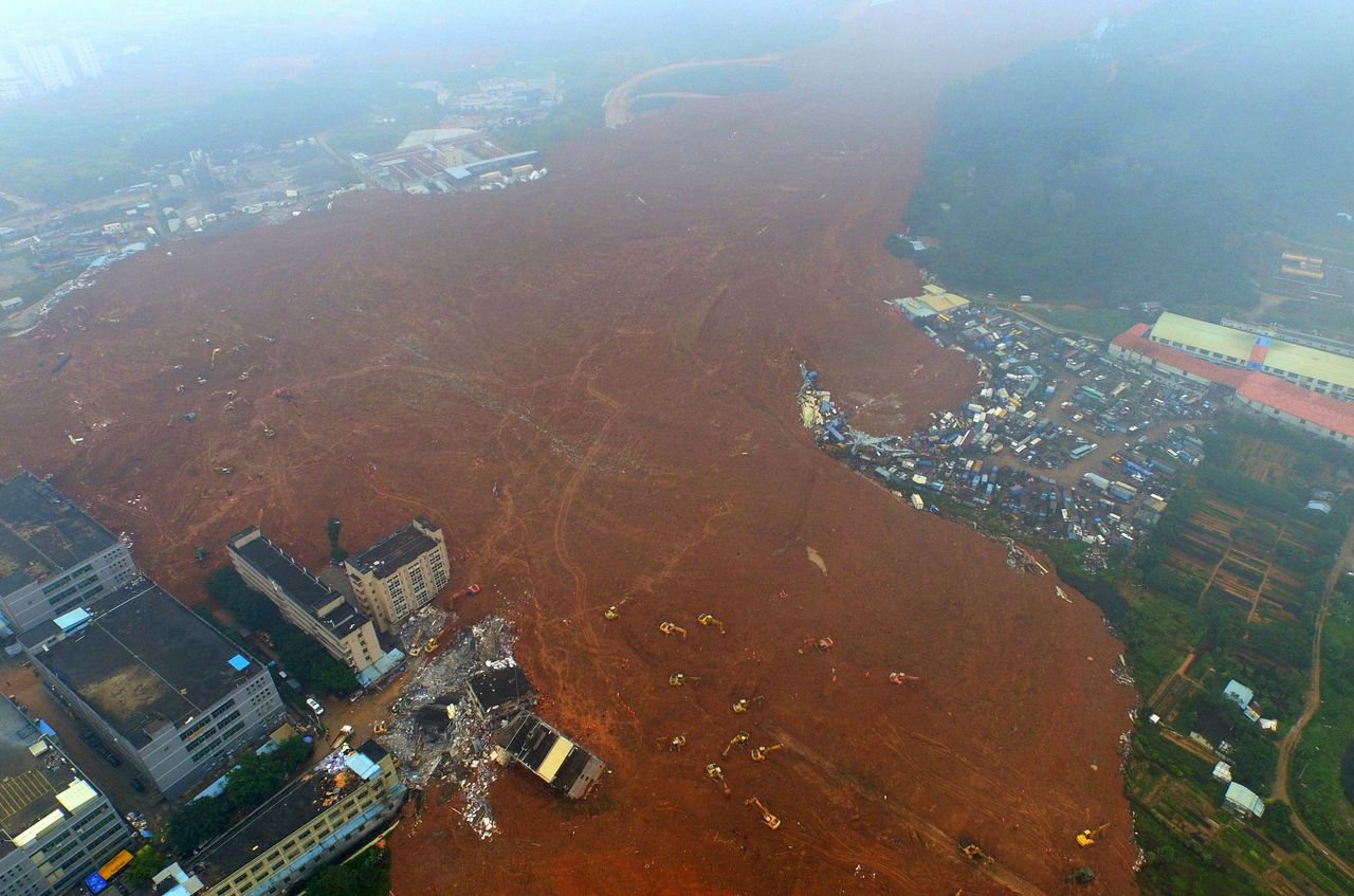 A landslide, caused by the combination of heavy rains and a pile of dirt and construction debris, spilled over an area of 4 million square feet and destroyed 33 buildings on Sunday.