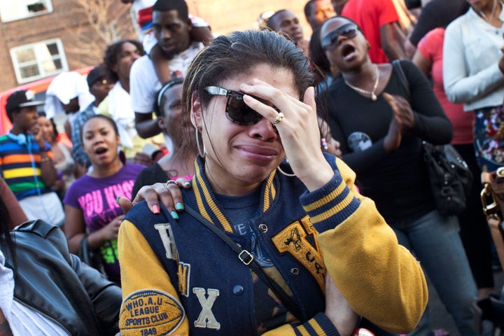 A woman cries during a vigil for Ramarley Graham outside the NYPD's 47th precinct on March 22, 2012.