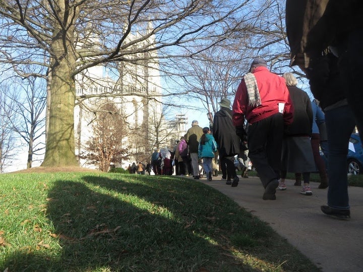 Clergy and community members walk toward the Washington National Cathedral, the second stop on Sunday’s interfaith pilgrimage in support of Muslims and unity between religious groups.