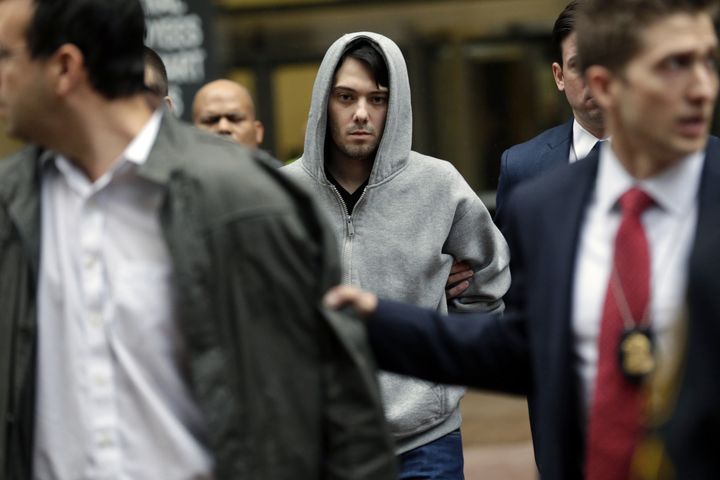 Martin Shkreli, chief executive officer of Turing Pharmaceuticals LLC, center, exits federal court in New York, U.S., on Thursday, Dec. 17, 2015. Shkreli was arrested on alleged securities fraud related to Retrophin Inc., a biotech firm he founded in 2011.