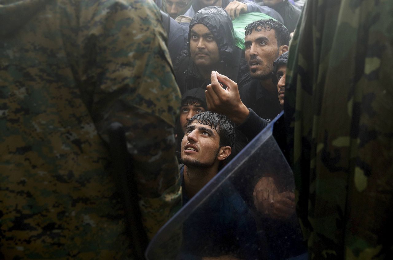 Europe's response to refugees and migrants has been a subject of fierce debate within the EU, as nations have shut their borders to stop the migration flows. In this photo, Behrakis captures people begging to cross into Macedonia.