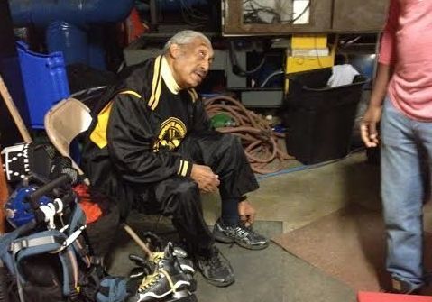 Neal Henderson, the founder of Fort Dupont Ice Hockey Club, talks to one of his former students before a practice in December 2014.