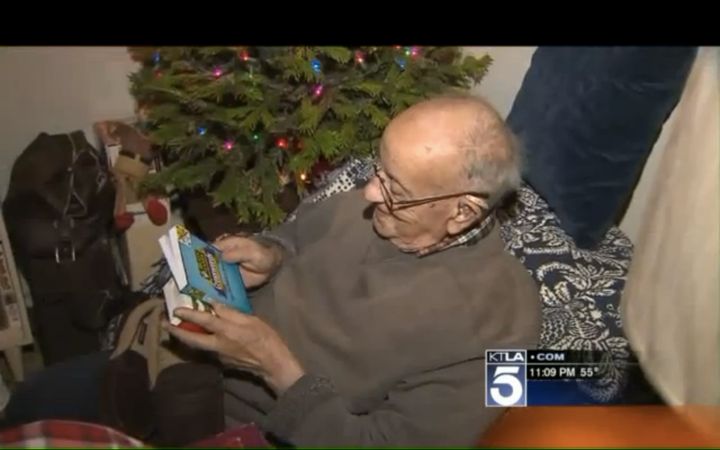 The 94-year-old WWII veteran is seen looking over crossword puzzles he was given as early Christmas presents.