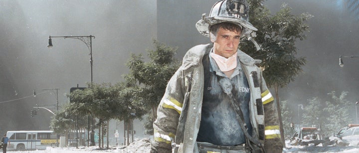 An unidentified New York City firefighter walks away from Ground Zero after the collapse of the World Trade Center on Sept. 11, 2001.