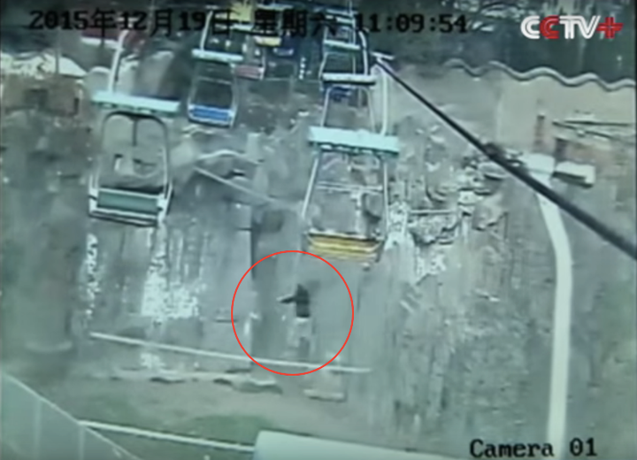 A man is seen landing on a net over a China zoo's tiger enclosure after jumping from a chairlift.