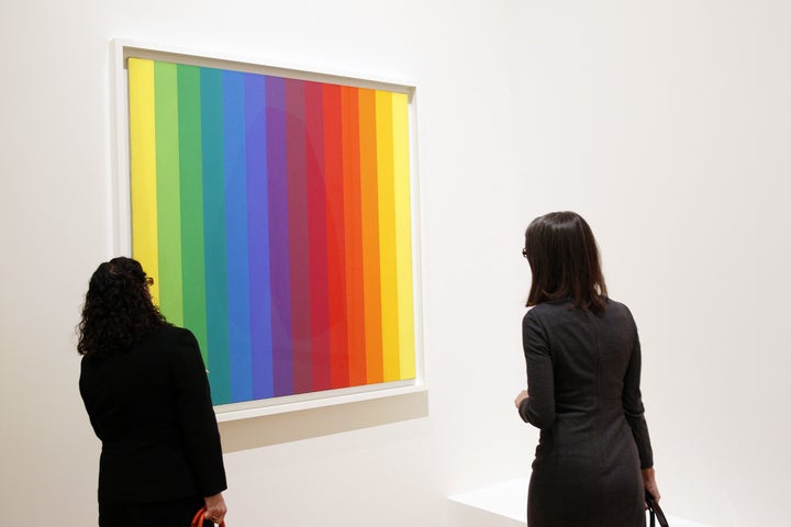 Visitors look at Kelly's "Spectrum!" painting at the "Icones Americaines" exhibition at the Grand Palais in Paris, France, in