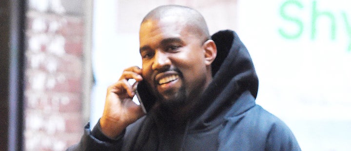 Kanye West with rare smile, probably ordering more presents.