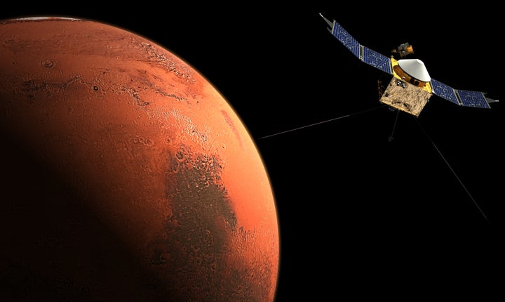 This image, courtesy of NASA, shows an artist concept of Mars and a spacecraft.